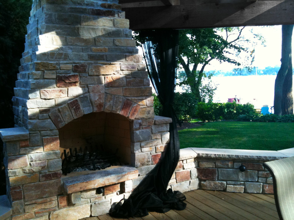 Large country backyard deck in Chicago with a fire feature and a pergola.