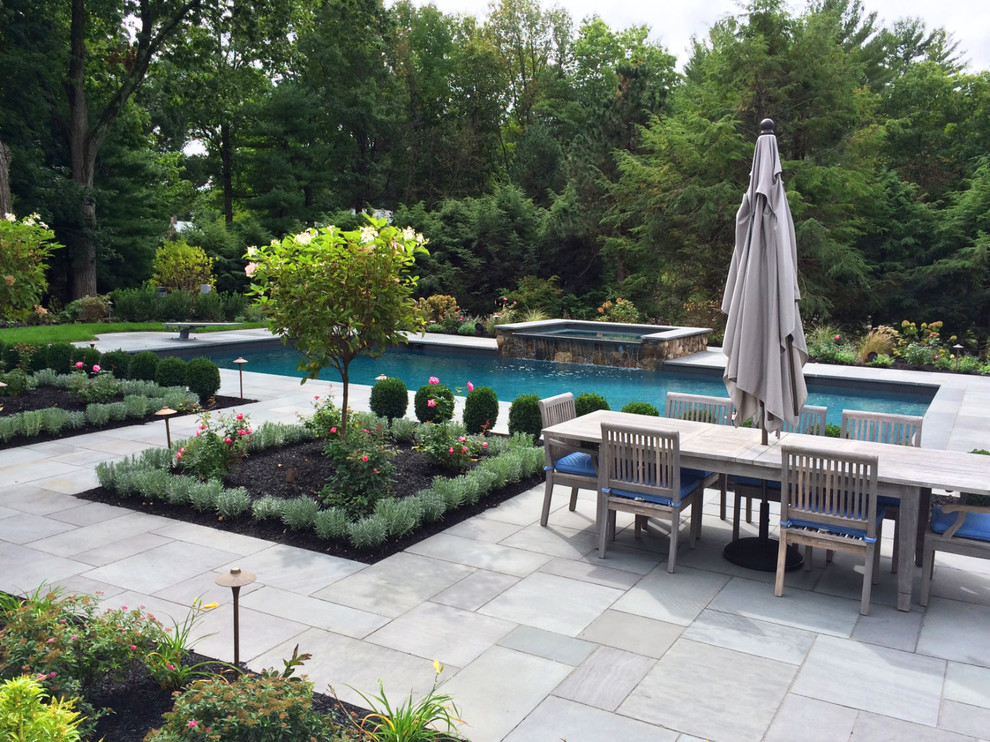 Large transitional backyard rectangular natural pool in Boston with a water feature and stamped concrete.