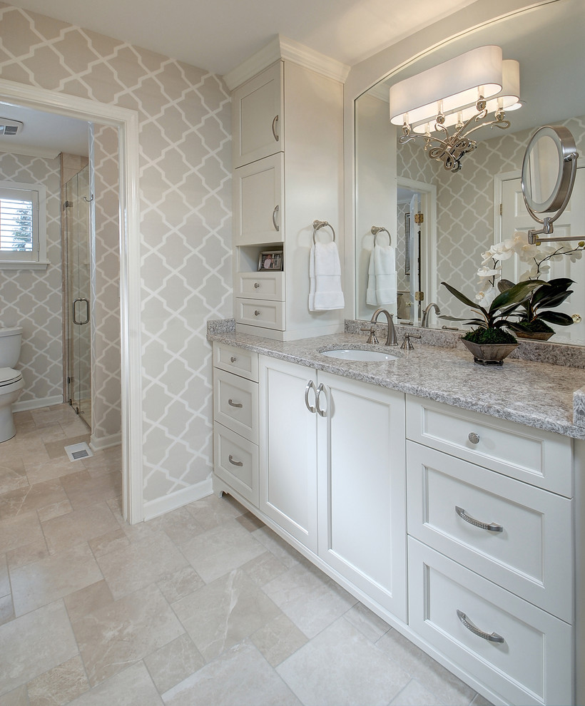 Corner shower - transitional master beige tile corner shower idea in New York with recessed-panel cabinets, white cabinets, a two-piece toilet and gray walls