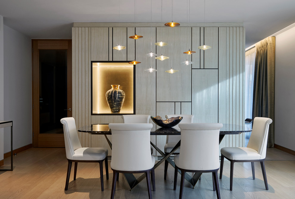 Contemporary dining room in London with white walls, light hardwood floors and beige floor.