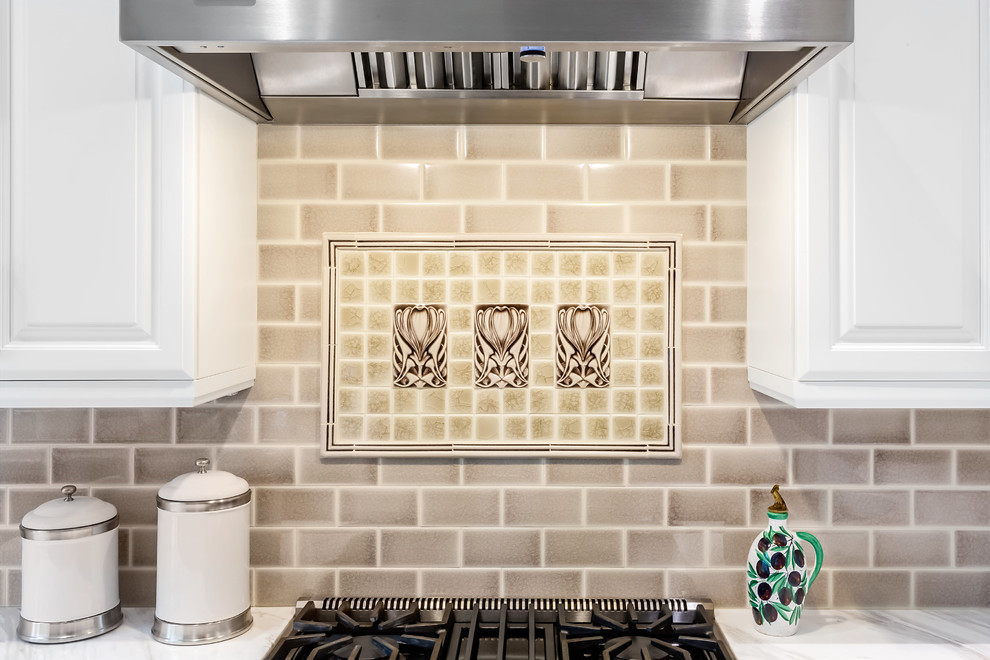 Kitchen pantry - mid-sized transitional u-shaped porcelain tile and white floor kitchen pantry idea in Seattle with an undermount sink, raised-panel cabinets, white cabinets, marble countertops, stainless steel appliances, an island, white countertops, brown backsplash and subway tile backsplash