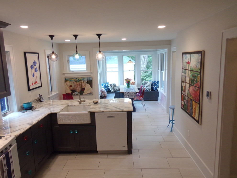 Example of a large transitional u-shaped porcelain tile eat-in kitchen design with a farmhouse sink, flat-panel cabinets, gray cabinets, marble countertops, white backsplash, ceramic backsplash, white appliances and no island