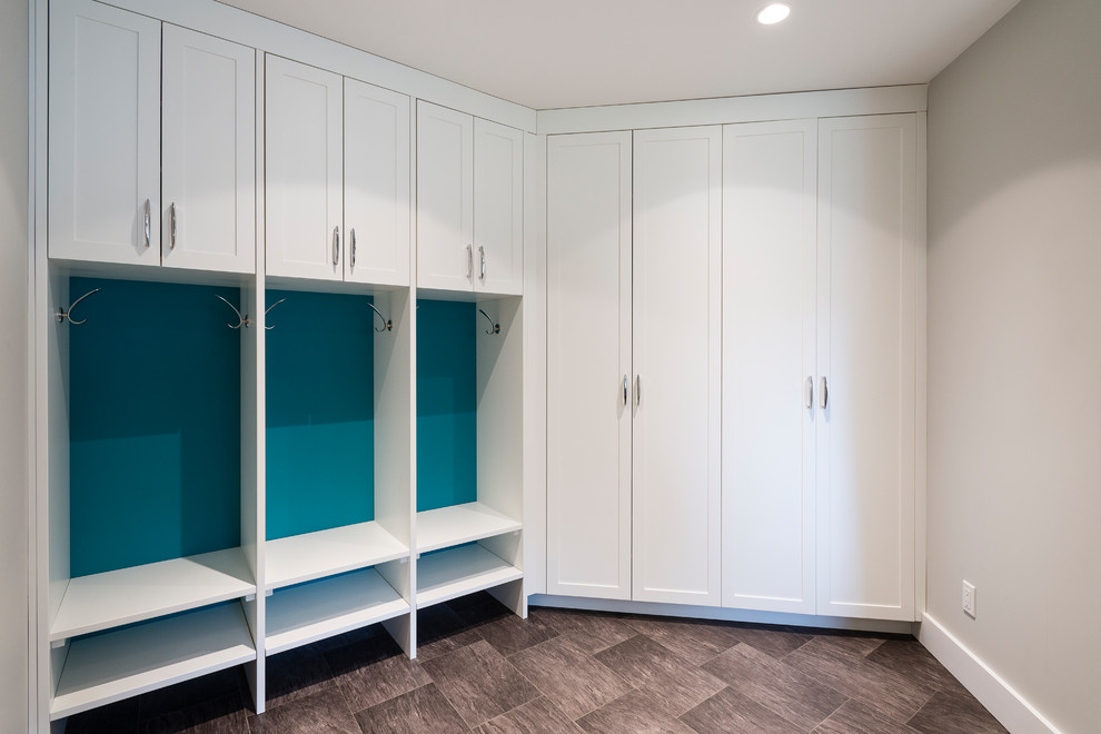 Photo of a mid-sized transitional single-wall utility room in Vancouver with an undermount sink, shaker cabinets, white cabinets, quartz benchtops, grey walls, linoleum floors and a side-by-side washer and dryer.