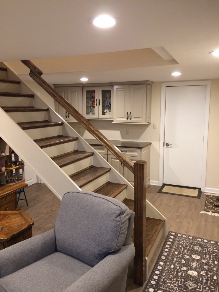 Design ideas for a mid-sized contemporary basement in Other with beige walls and medium hardwood floors.