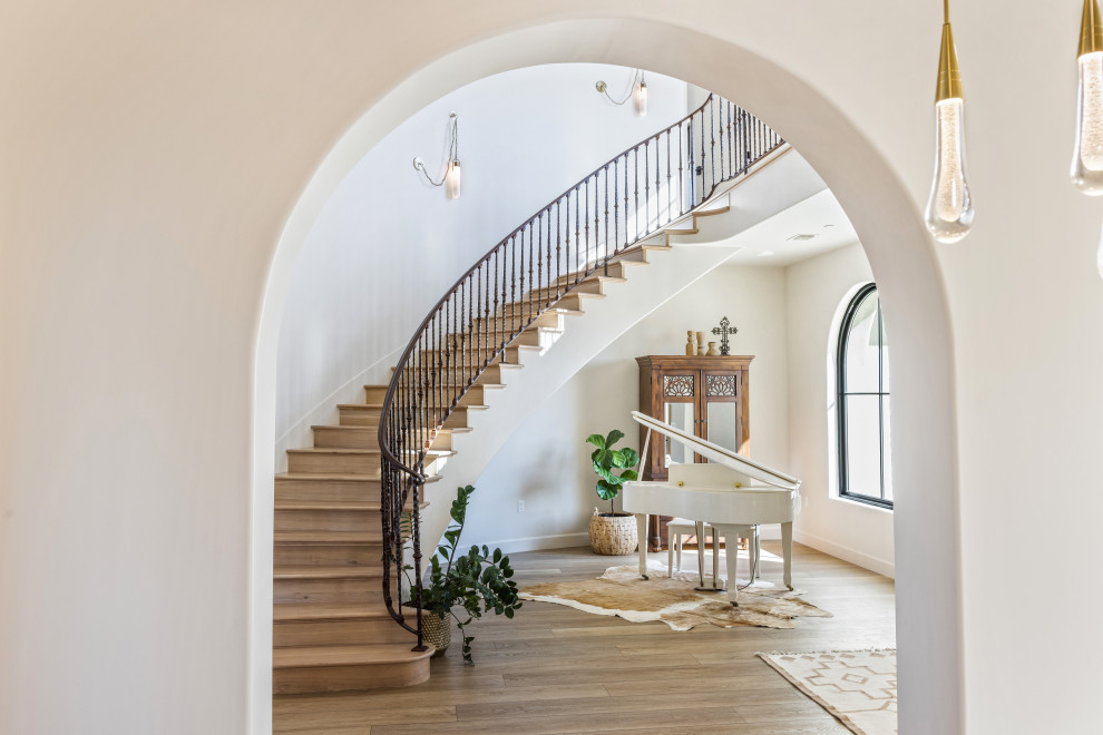 Foyer Arched Opening and Curved Staircase | Tuscan Farmhouse