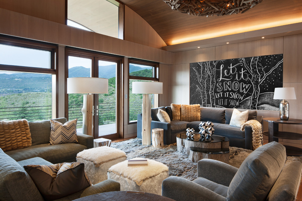 Design ideas for an expansive contemporary enclosed family room in Denver with beige walls, dark hardwood floors, no fireplace, a built-in media wall and brown floor.