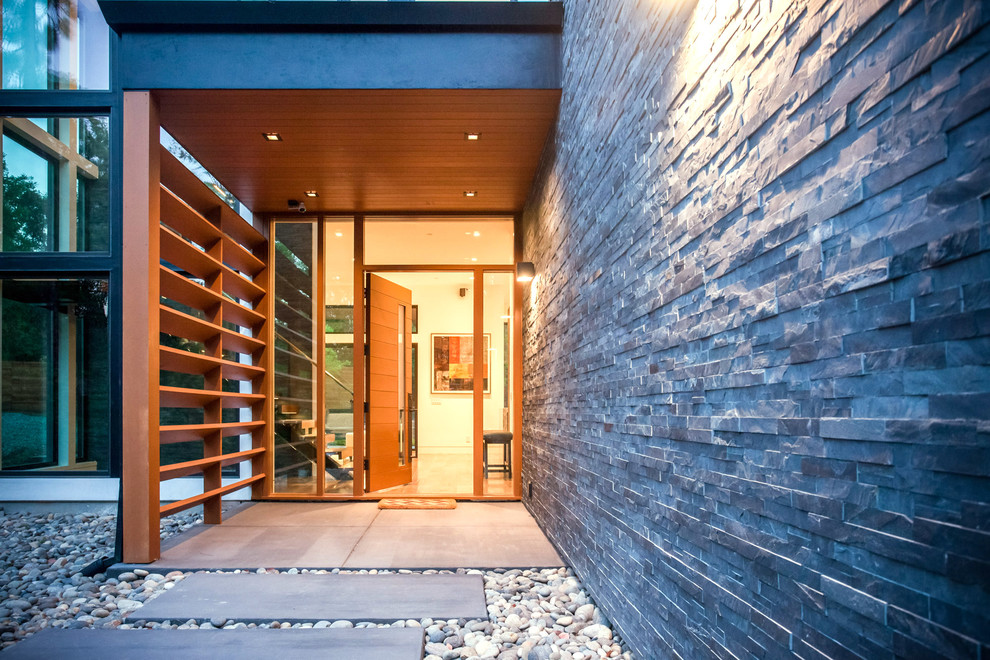 Front door - large modern front door idea in San Francisco with a light wood front door