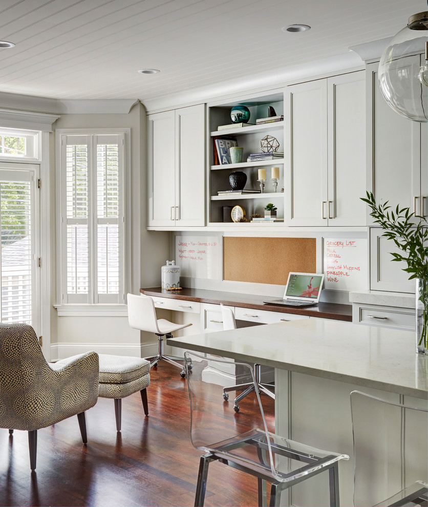 Inspiration for a small transitional built-in desk dark wood floor and brown floor home office remodel in Chicago with white walls