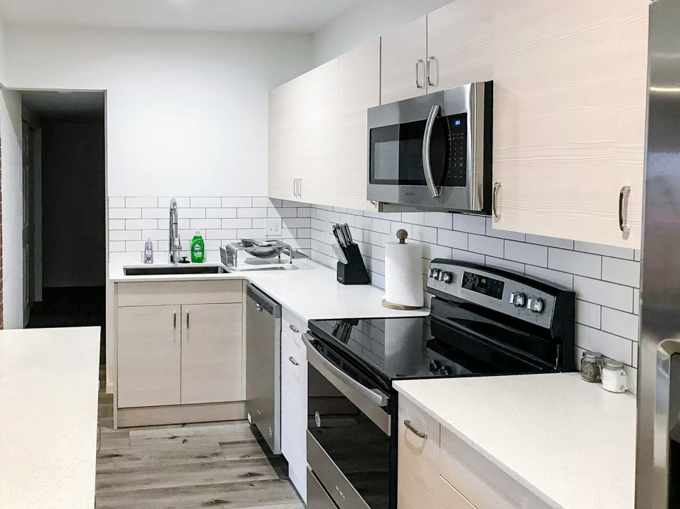 Photo of a small modern single-wall eat-in kitchen in Seattle with an undermount sink, white splashback, ceramic splashback, stainless steel appliances, light hardwood floors, with island and beige floor.