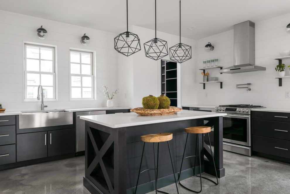 Design ideas for a mid-sized modern u-shaped open plan kitchen in Other with a farmhouse sink, flat-panel cabinets, black cabinets, quartz benchtops, white splashback, shiplap splashback, stainless steel appliances, concrete floors, with island, grey floor and white benchtop.