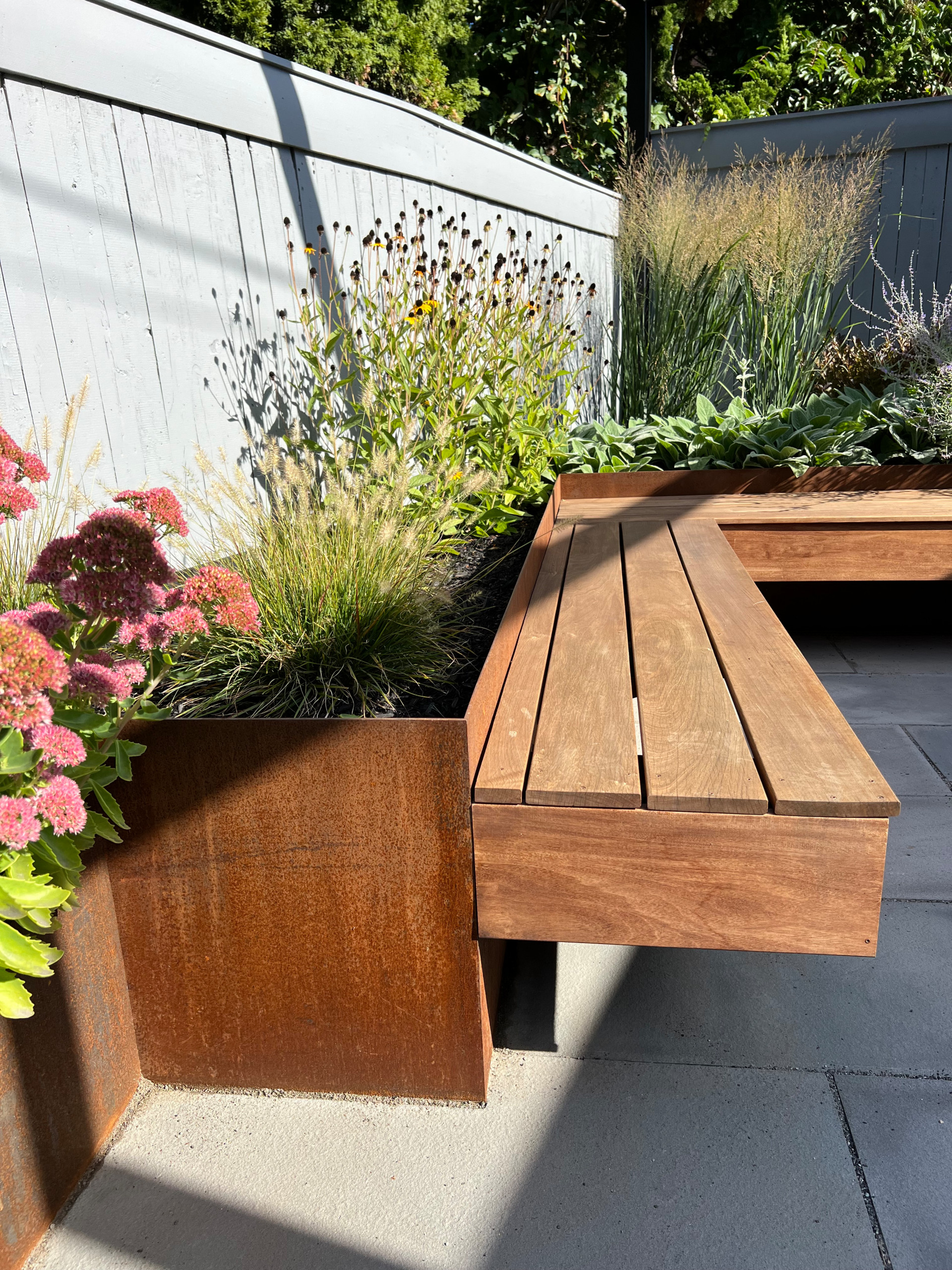 Paved patio with metal grating garden