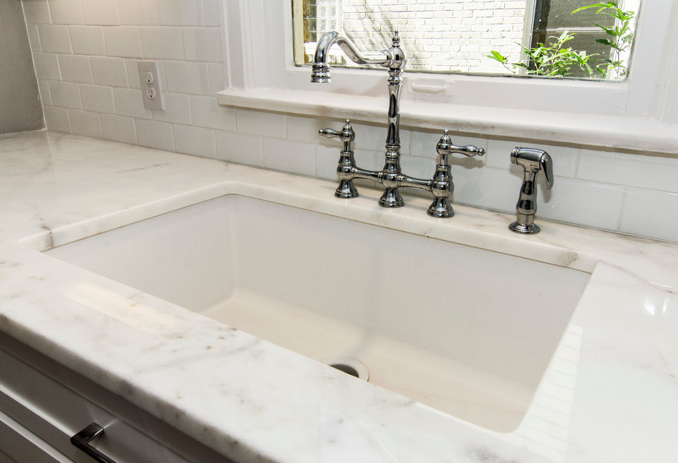 Eat-in kitchen - transitional galley eat-in kitchen idea in Dallas with an undermount sink, shaker cabinets, white cabinets, marble countertops, white backsplash, subway tile backsplash and stainless steel appliances