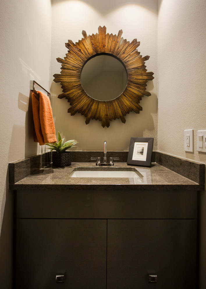Small transitional powder room in Raleigh with flat-panel cabinets, grey cabinets, a one-piece toilet, grey walls, dark hardwood floors, an undermount sink and granite benchtops.