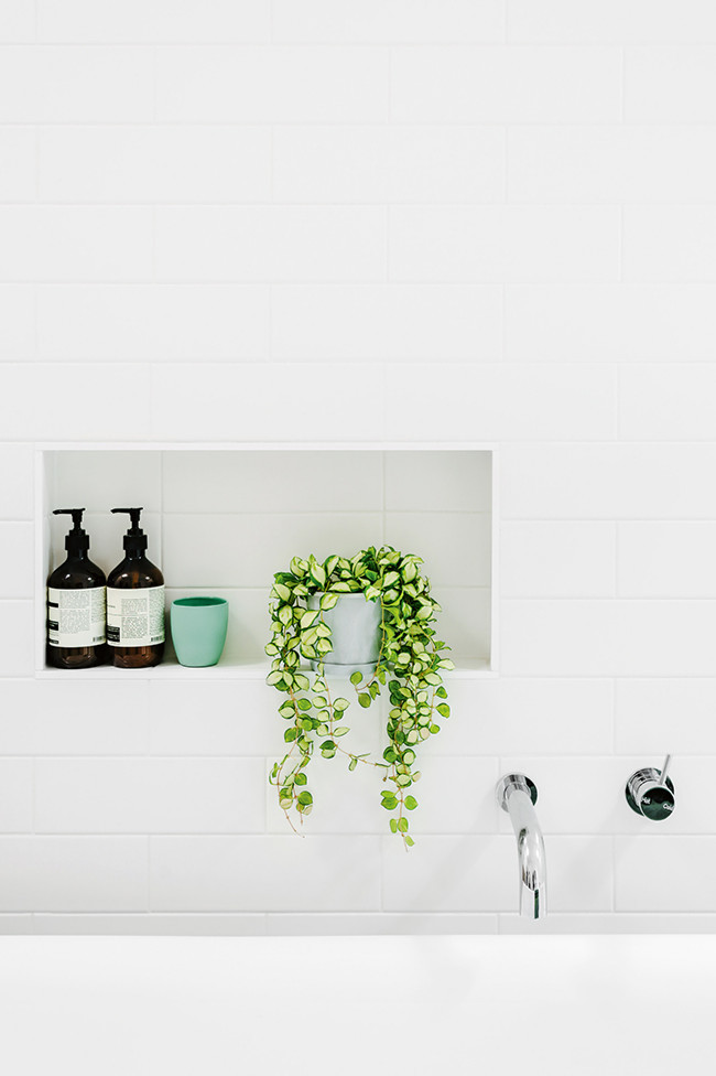 Photo of a mid-sized scandinavian master bathroom in Other with an undermount sink, a freestanding tub, a curbless shower, white tile and white walls.