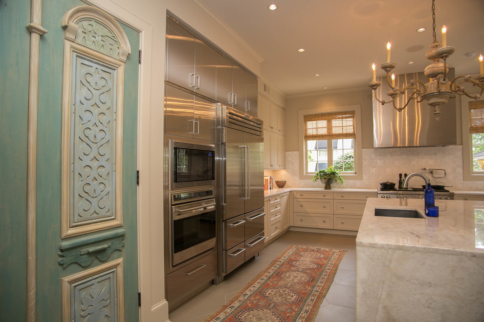 Inspiration for a mid-sized transitional u-shaped kitchen in New Orleans with an undermount sink, recessed-panel cabinets, beige cabinets, quartzite benchtops, beige splashback, mosaic tile splashback, stainless steel appliances and with island.