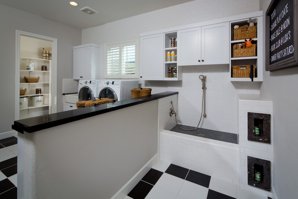 Inspiration for an expansive utility room in Orange County with grey walls, ceramic floors, white cabinets and a side-by-side washer and dryer.