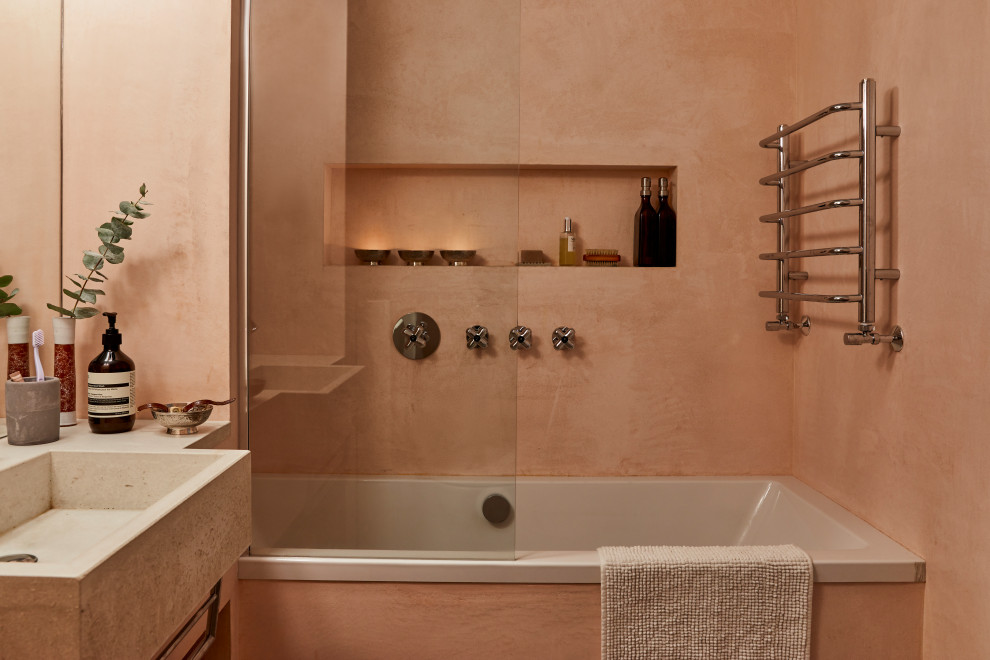 Inspiration for a retro shower room bathroom in Berlin with an alcove bath, a shower/bath combination, orange tiles, orange walls, an integrated sink, concrete worktops, an open shower, grey worktops, a single sink and a wall niche.