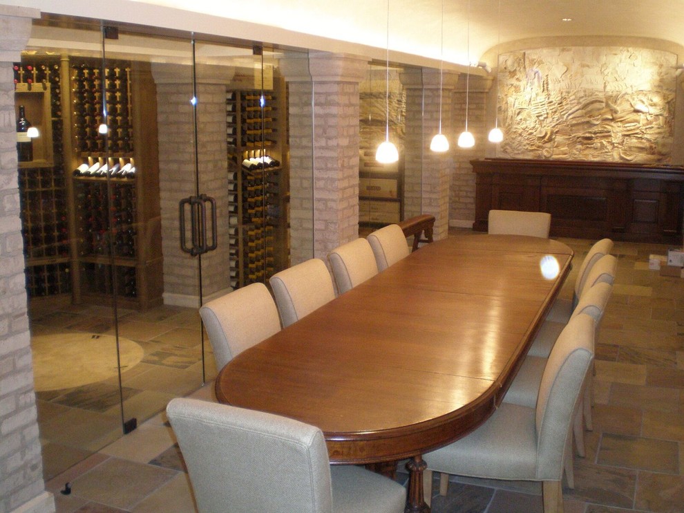 Expansive midcentury wine cellar in St Louis with travertine floors and storage racks.