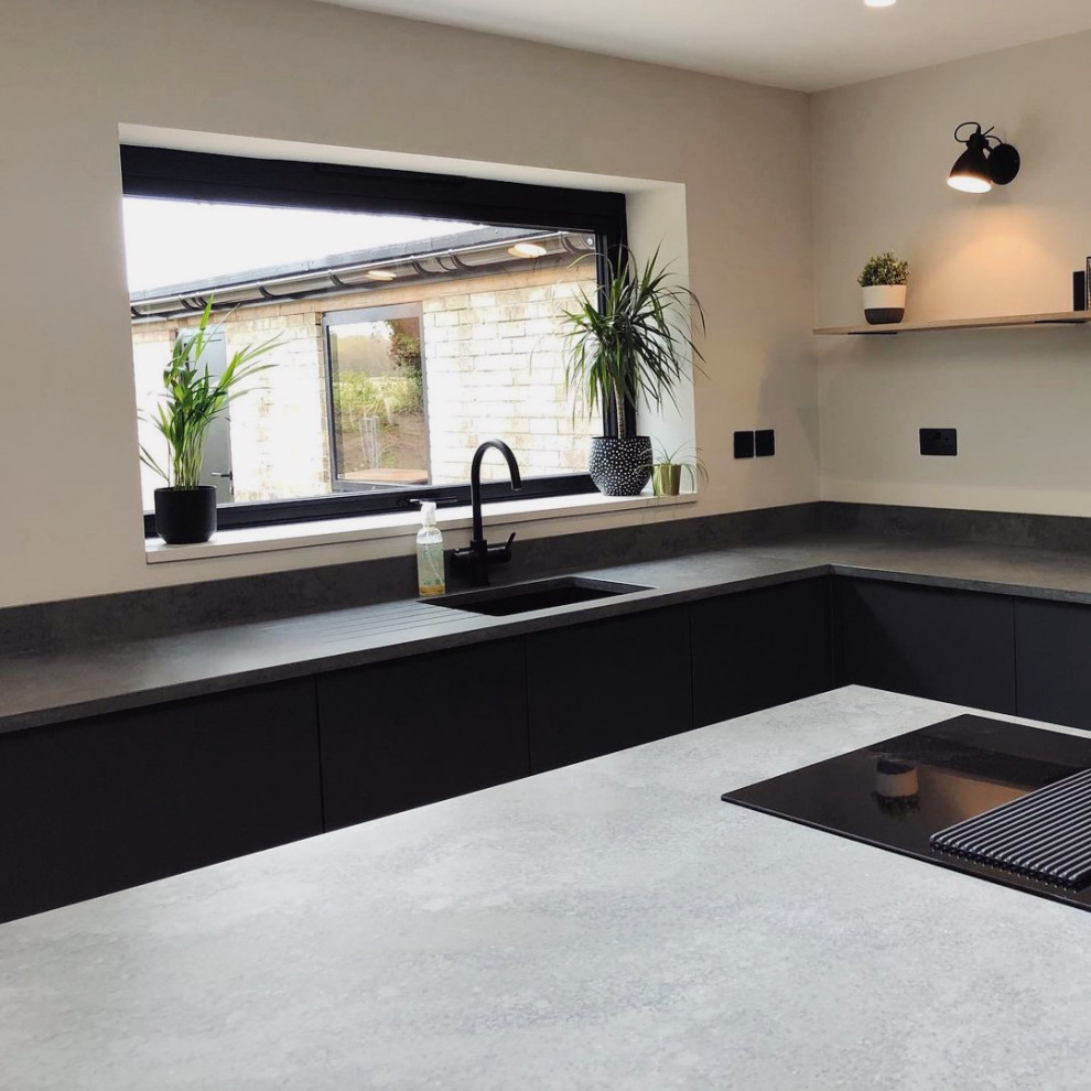Inspiration for a contemporary grey and black kitchen in Other with quartz worktops, an island and grey worktops.