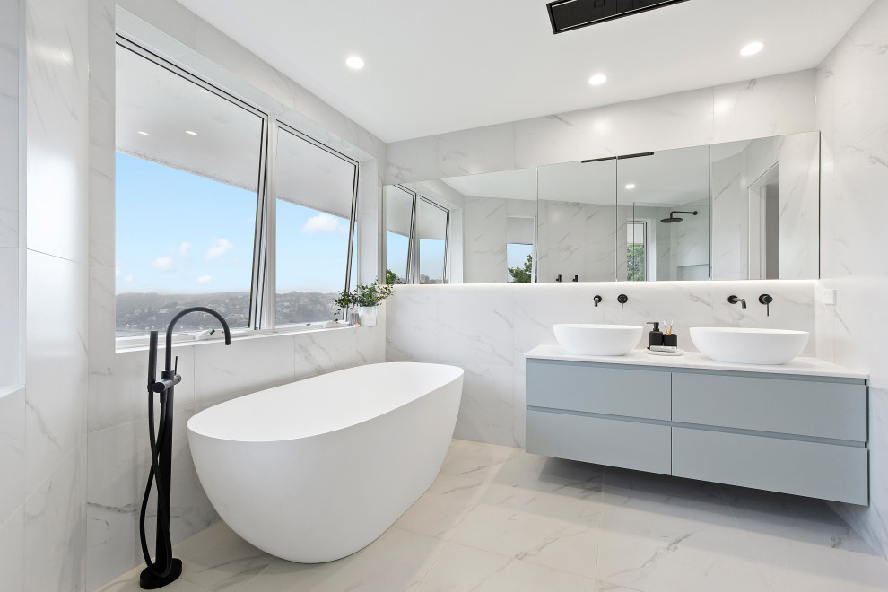 Inspiration for a large contemporary master white tile double-sink bathroom remodel in Sydney with flat-panel cabinets, gray cabinets, a two-piece toilet, a vessel sink, white countertops, a niche and a floating vanity