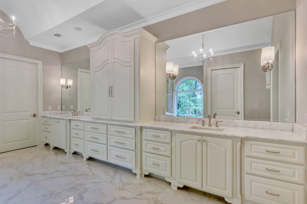 Design ideas for a large master bathroom in Houston with raised-panel cabinets, white cabinets, a claw-foot tub, a corner shower, beige walls, an undermount sink, brown floor, a hinged shower door, white benchtops, a niche, a double vanity, a built-in vanity and vaulted.
