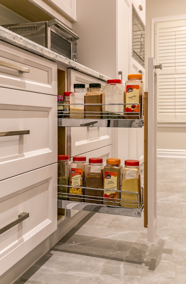 Inspiration for a large transitional gray floor enclosed kitchen remodel in Toronto with an undermount sink, recessed-panel cabinets, white cabinets, quartz countertops, white backsplash, ceramic backsplash, stainless steel appliances and an island