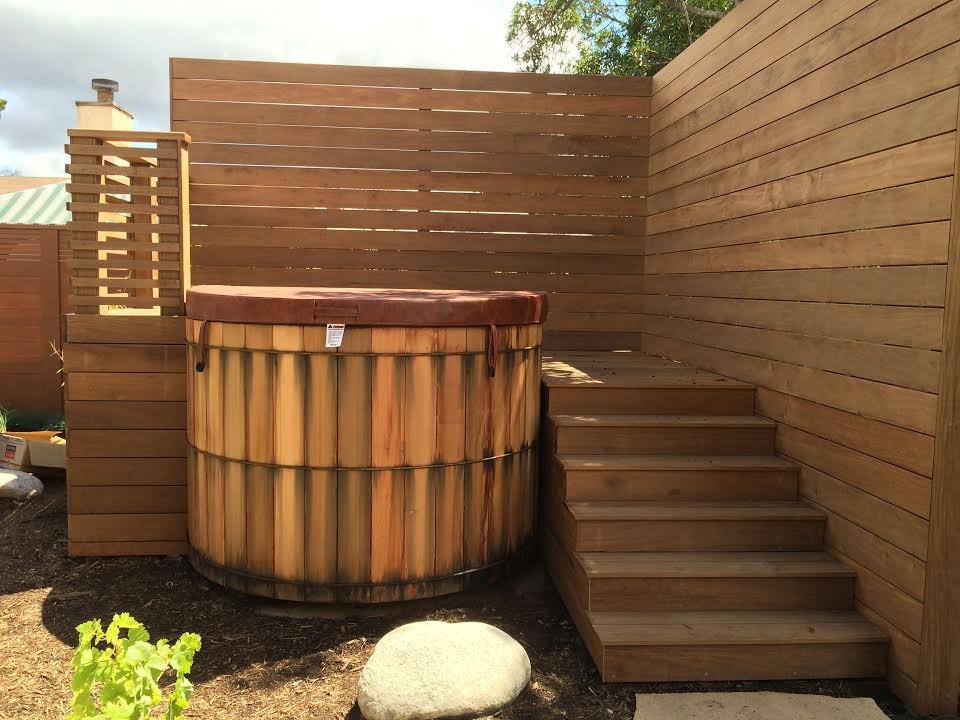 Inspiration for a small arts and crafts backyard round aboveground pool in San Diego with a hot tub and decking.