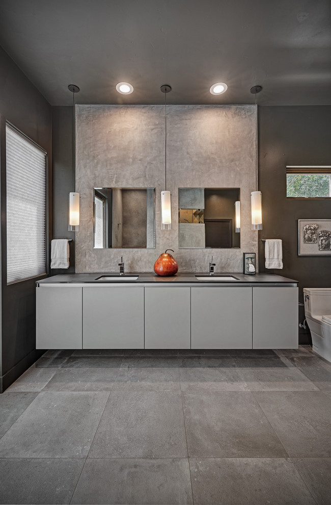 Inspiration for an expansive contemporary master bathroom in Sacramento with flat-panel cabinets, grey cabinets, a freestanding tub, an open shower, a one-piece toilet, white tile, black walls, cement tiles, an undermount sink, engineered quartz benchtops, multi-coloured floor, an open shower, black benchtops, a double vanity and a floating vanity.