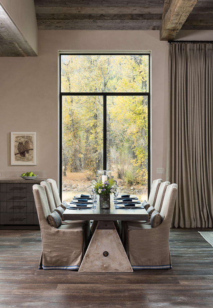 This is an example of an expansive country dining room in Sacramento with beige walls and dark hardwood floors.