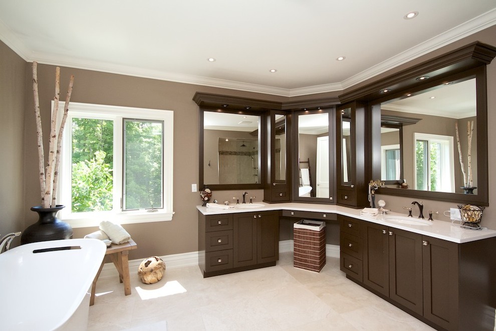 Contemporary bathroom in Toronto with an undermount sink, flat-panel cabinets, dark wood cabinets, engineered quartz benchtops, a freestanding tub, beige tile, beige walls and porcelain floors.