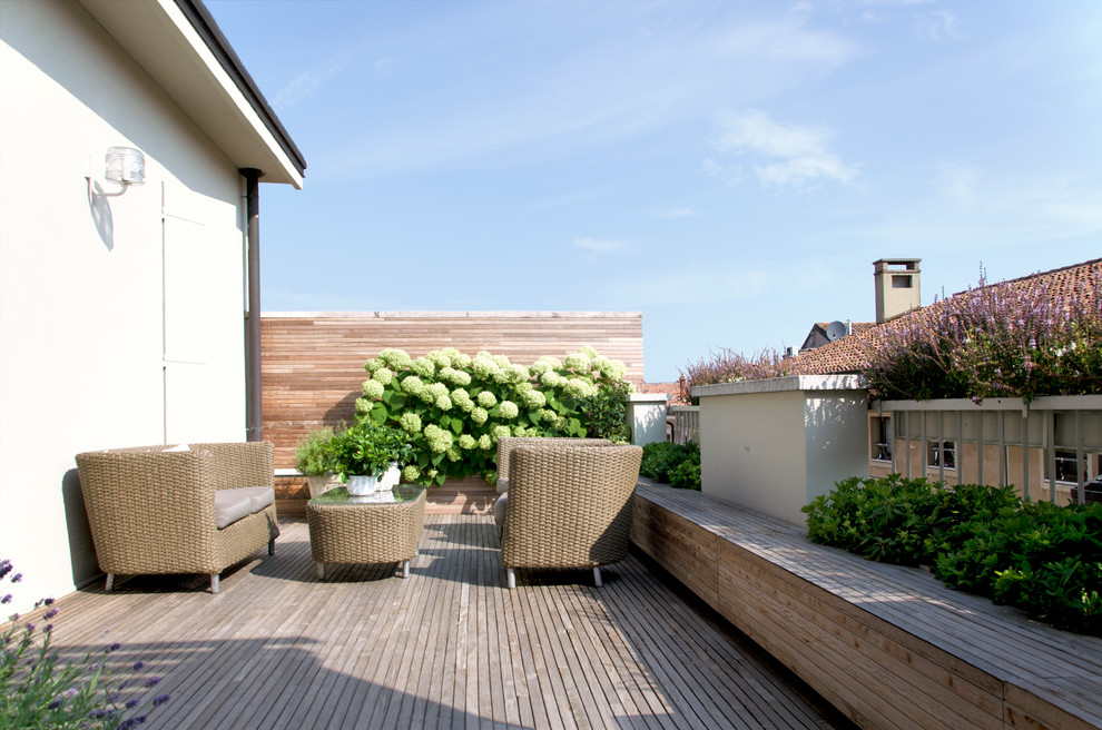 Photo of an expansive contemporary rooftop deck in Other with a pergola.