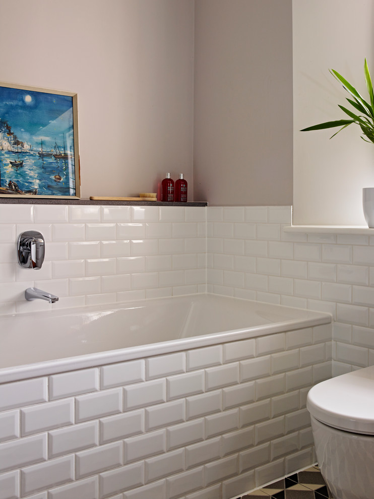 Inspiration for a mid-sized traditional kids bathroom in Devon with a wall-mount sink, flat-panel cabinets, medium wood cabinets, a drop-in tub, a curbless shower, a one-piece toilet, white tile, porcelain tile, brown walls and ceramic floors.