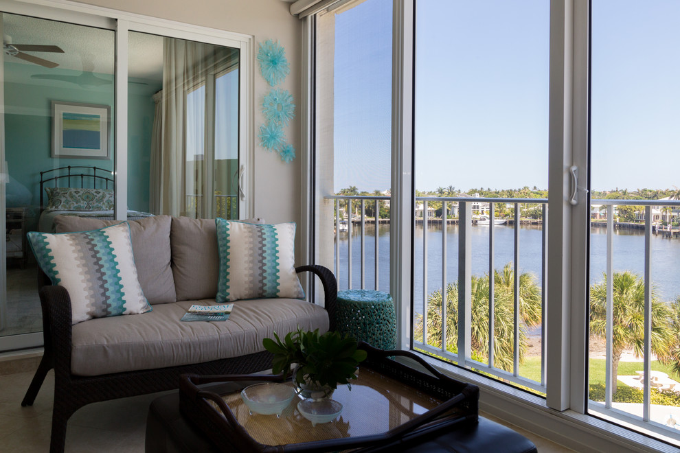 This is an example of a beach style balcony in Miami with a roof extension.