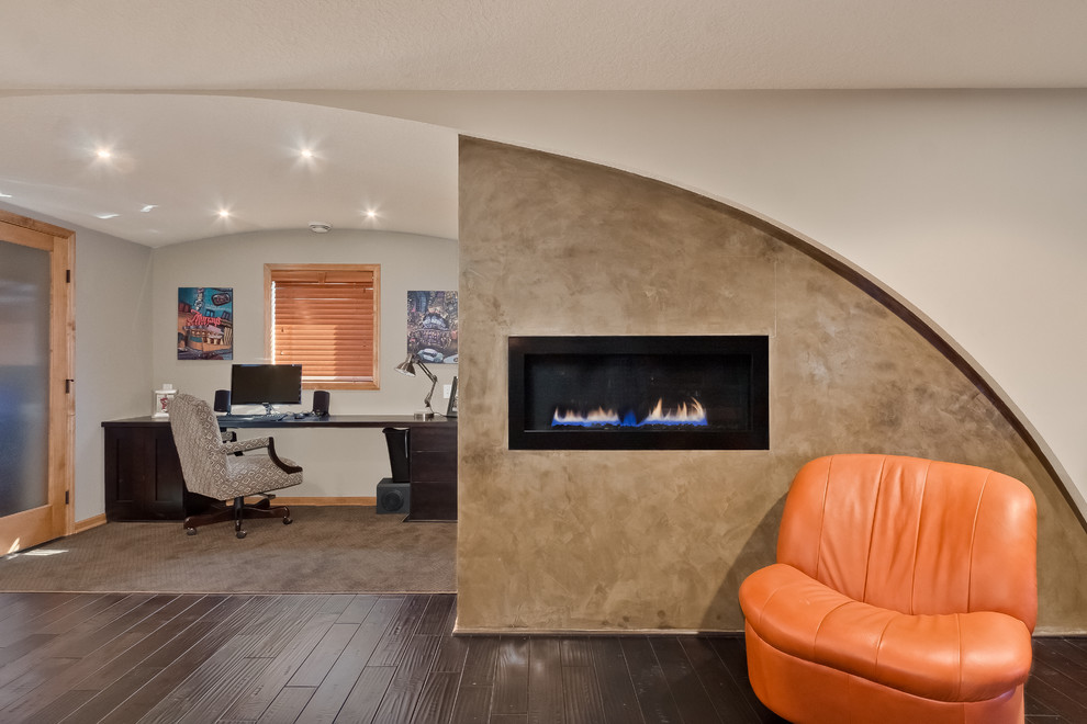 Mid-sized contemporary study room in Minneapolis with white walls, dark hardwood floors, a ribbon fireplace, a concrete fireplace surround, a freestanding desk and brown floor.