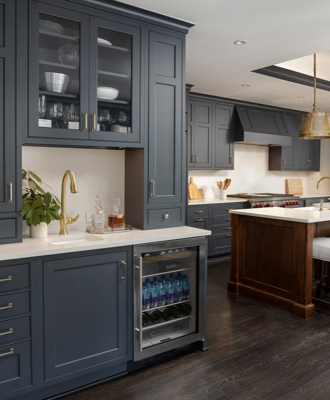This is an example of a mid-sized transitional l-shaped separate kitchen in DC Metro with a single-bowl sink, recessed-panel cabinets, blue cabinets, quartz benchtops, white splashback, stone slab splashback, panelled appliances, dark hardwood floors, with island, brown floor and white benchtop.