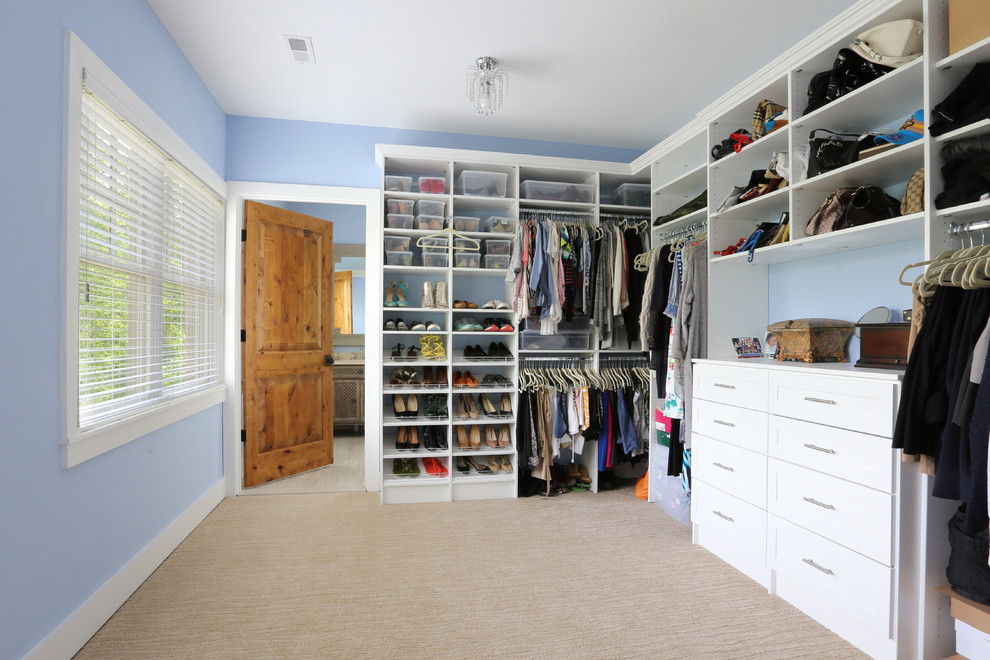 Mid-sized traditional gender-neutral walk-in wardrobe in DC Metro with open cabinets, white cabinets, carpet and beige floor.