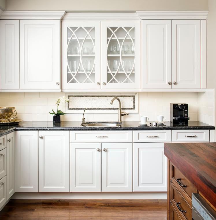Kitchen pantry - large transitional l-shaped dark wood floor kitchen pantry idea in Orange County with a double-bowl sink, flat-panel cabinets, white cabinets, granite countertops, white backsplash, subway tile backsplash, stainless steel appliances and an island
