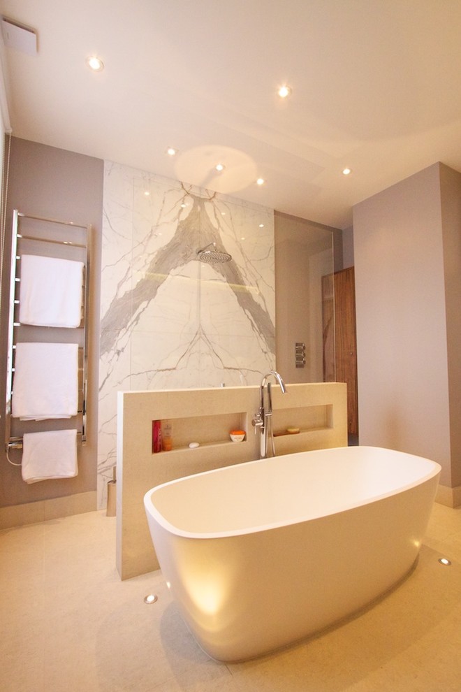 Contemporary bathroom in London with a freestanding tub and beige walls.