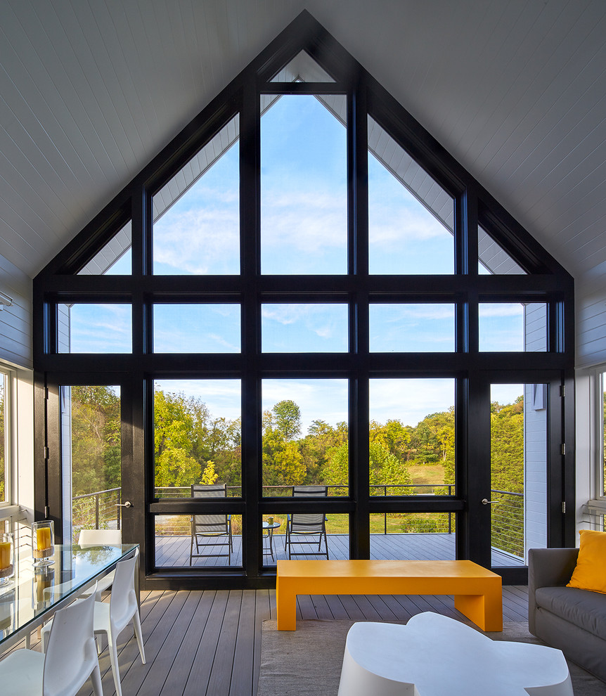 Inspiration for a large contemporary screened-in back porch remodel in DC Metro with decking and a roof extension