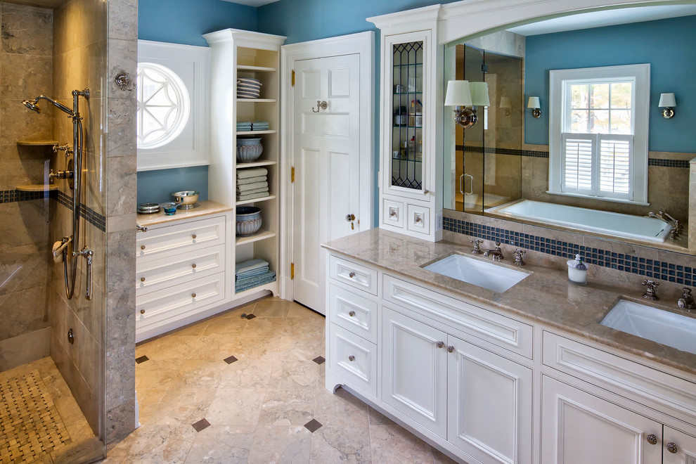 Design ideas for a large traditional master bathroom in New York with marble benchtops, beige floor, brown benchtops, beaded inset cabinets, white cabinets, a drop-in tub, a corner shower, blue tile, glass tile, blue walls, marble floors, an undermount sink and a hinged shower door.