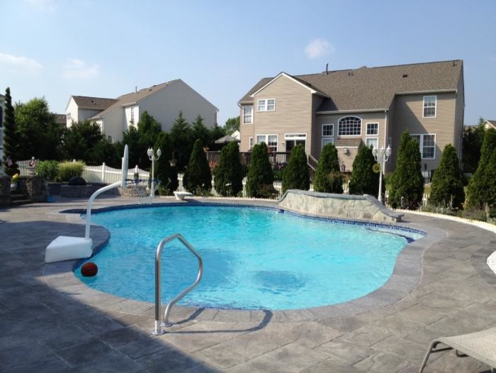 Pool fountain - large backyard stone and custom-shaped natural pool fountain idea in Baltimore