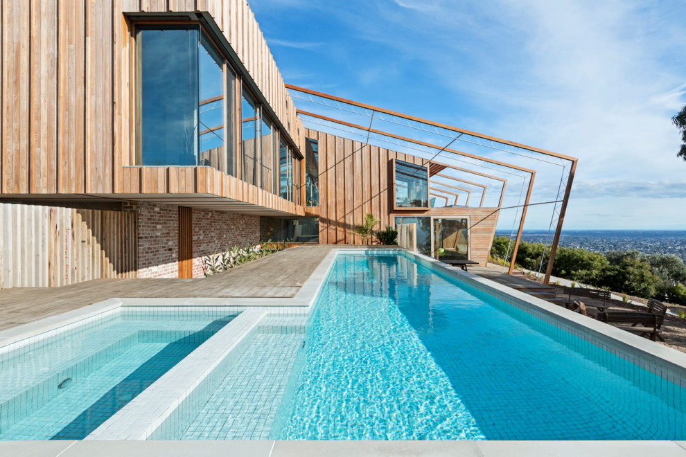 Photo of a contemporary l-shaped pool in Melbourne with a hot tub and decking.