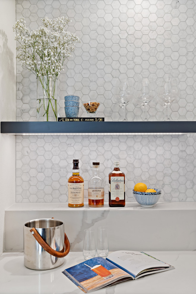 Inspiration for a small contemporary single-wall wet bar in San Francisco with an undermount sink, shaker cabinets, blue cabinets, quartz benchtops, white splashback, marble splashback, vinyl floors, brown floor and white benchtop.