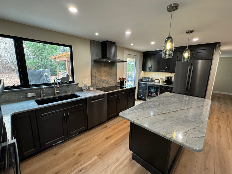 Inspiration for a mid-sized transitional u-shaped laminate floor and brown floor eat-in kitchen remodel in Boston with an undermount sink, shaker cabinets, brown cabinets, quartz countertops, black appliances, an island and multicolored countertops