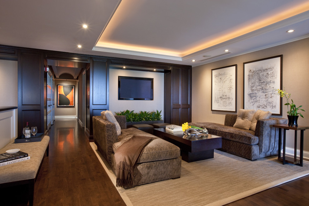 Inspiration for a contemporary family room in Chicago with beige walls, dark hardwood floors and a wall-mounted tv.