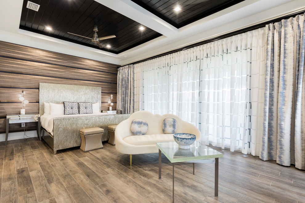 This is an example of a contemporary bedroom in Orlando with brown walls and brown floor.
