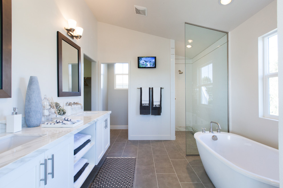 Inspiration for a country bathroom in Orange County with an undermount sink, shaker cabinets, white cabinets, a freestanding tub, an open shower, white tile, subway tile, white walls and an open shower.