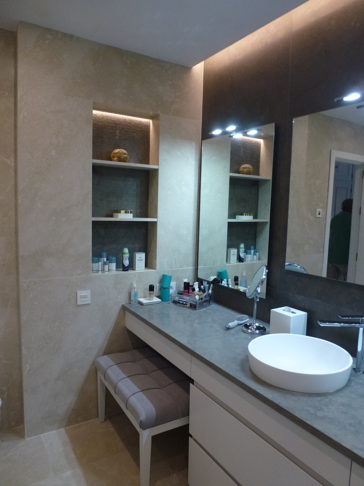 Mid-sized modern master bathroom in Other with flat-panel cabinets, beige cabinets, a curbless shower, a wall-mount toilet, beige tile, marble, beige walls, marble floors, a vessel sink, marble benchtops, beige floor, a sliding shower screen and green benchtops.