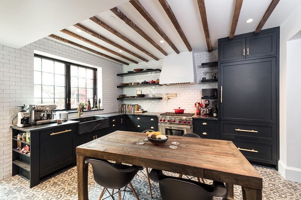 Inspiration for a small transitional l-shaped kitchen in DC Metro with a farmhouse sink, shaker cabinets, black cabinets, stainless steel appliances and no island.
