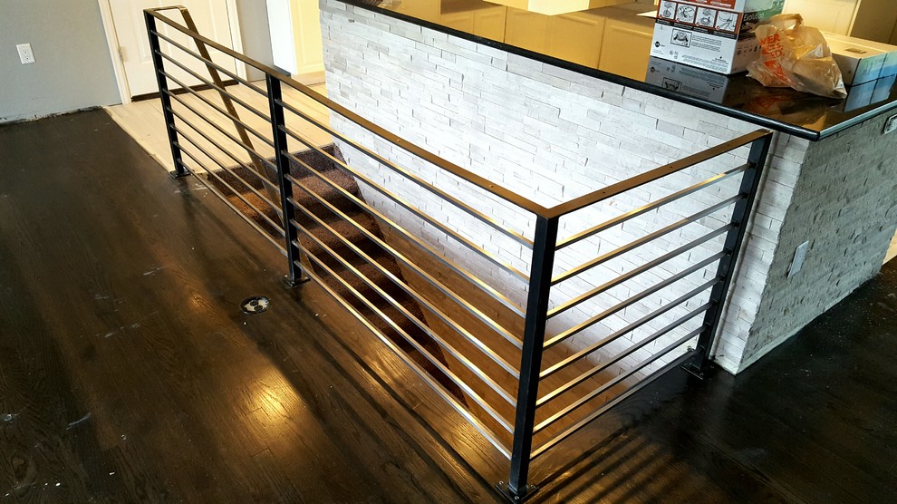 Small contemporary carpeted straight staircase in Denver with carpet risers and metal railing.